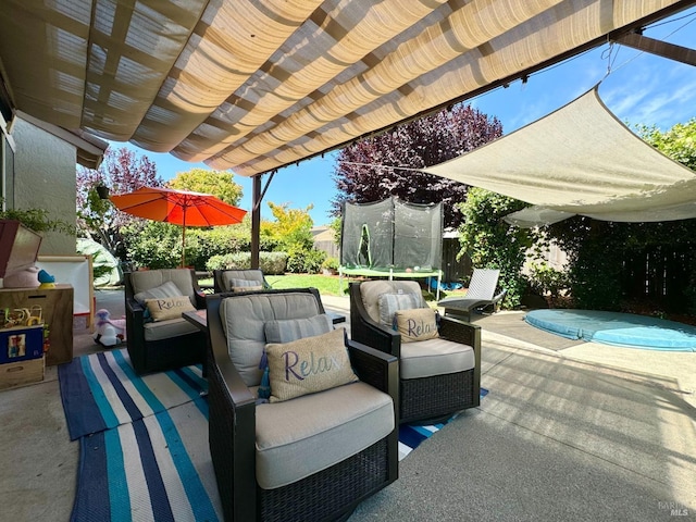 view of patio featuring fence, a trampoline, outdoor lounge area, and a pergola