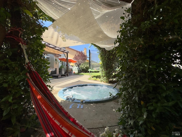 view of swimming pool featuring a patio and a trampoline