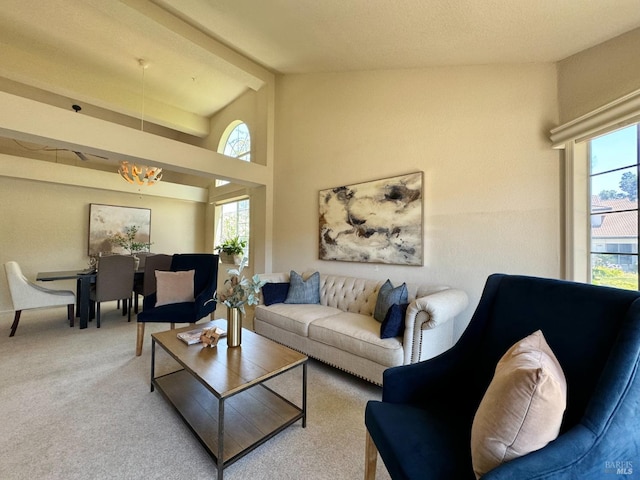 carpeted living area featuring beamed ceiling and high vaulted ceiling