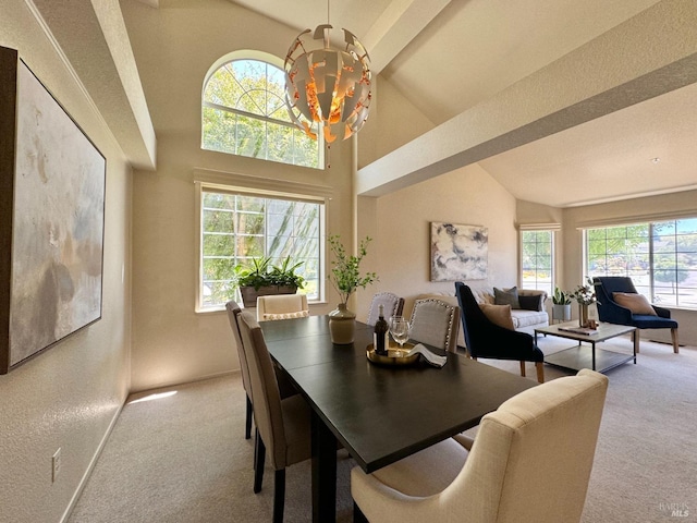 dining area with light colored carpet, a wealth of natural light, and a chandelier