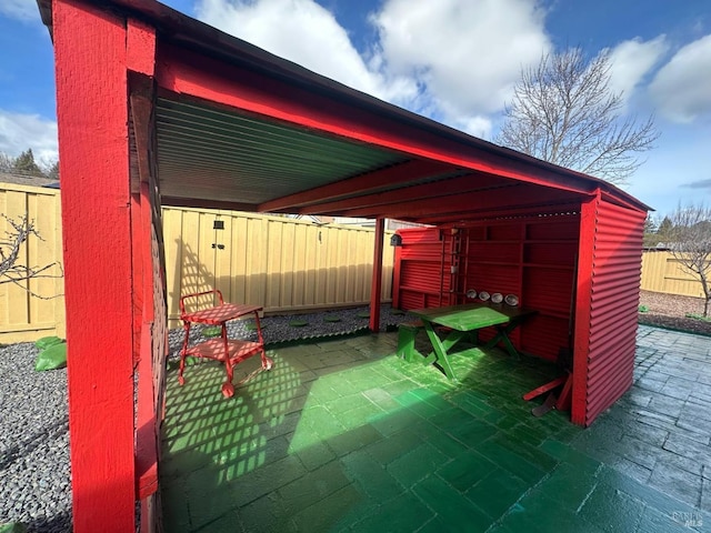 view of patio featuring an outbuilding and a fenced backyard