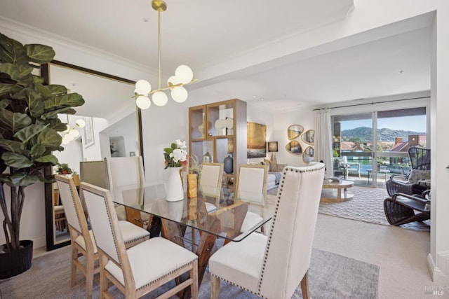 carpeted dining space with an inviting chandelier and crown molding