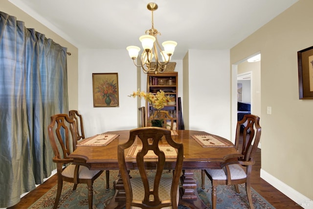 dining space featuring an inviting chandelier, baseboards, and dark wood-style flooring