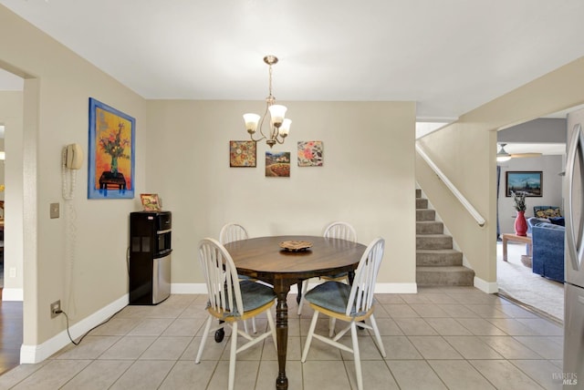 dining space with light tile patterned floors, baseboards, stairway, and an inviting chandelier