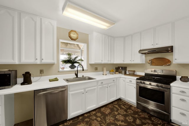 kitchen with under cabinet range hood, a sink, white cabinetry, and appliances with stainless steel finishes