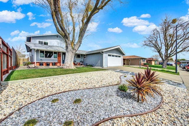 view of front of house featuring concrete driveway, a front lawn, fence, and an attached garage