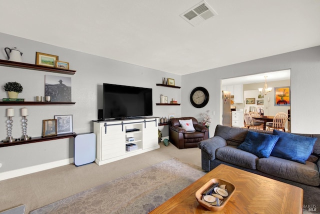 living room with an inviting chandelier, carpet flooring, and visible vents