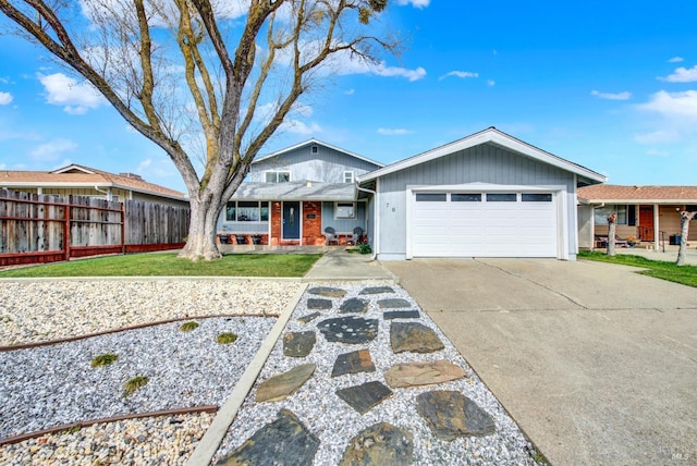 view of front facade featuring concrete driveway, a garage, a front yard, and fence