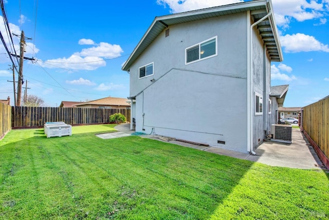 rear view of property with central AC, a fenced backyard, stucco siding, a lawn, and a patio area