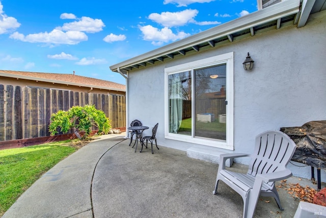 view of patio featuring fence