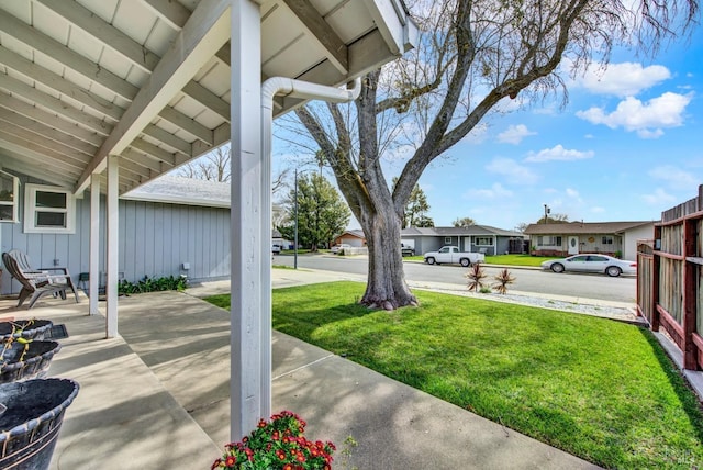 view of yard featuring a residential view and a patio