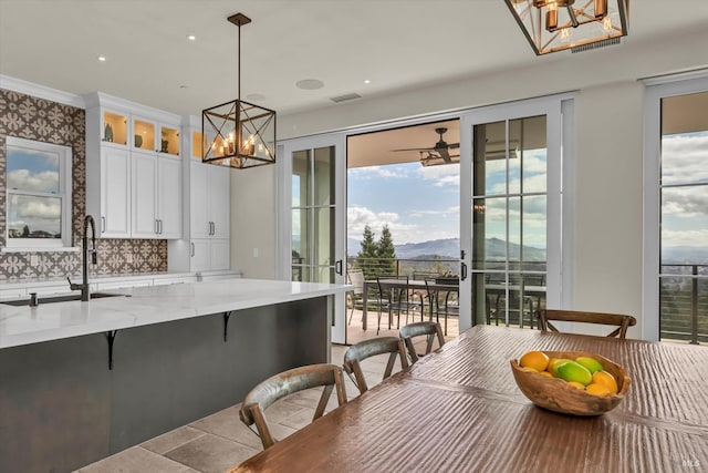 dining area featuring a mountain view, visible vents, and a notable chandelier