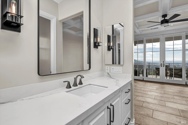 bathroom featuring ornamental molding, a ceiling fan, wood tiled floor, beam ceiling, and coffered ceiling