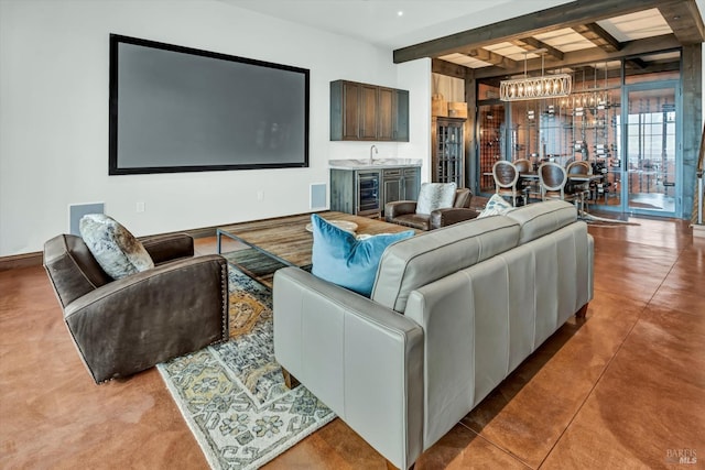 living room with wet bar, a notable chandelier, beverage cooler, and beam ceiling