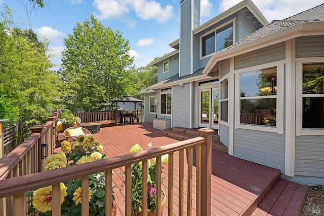 wooden terrace featuring fence