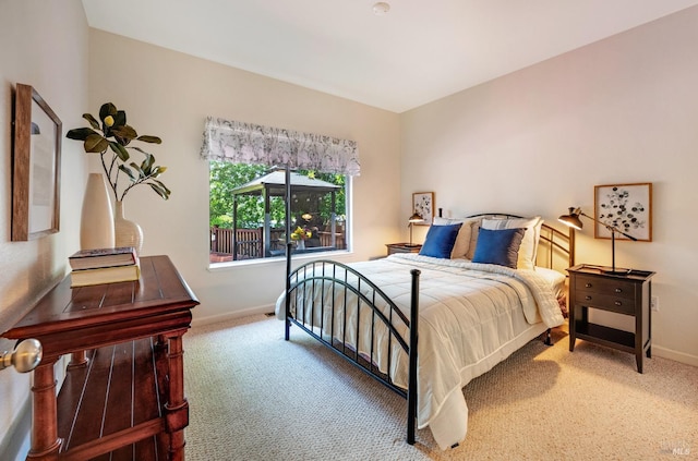 carpeted bedroom featuring baseboards