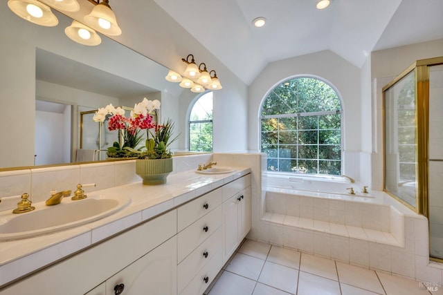 bathroom featuring a sink, double vanity, a stall shower, and vaulted ceiling