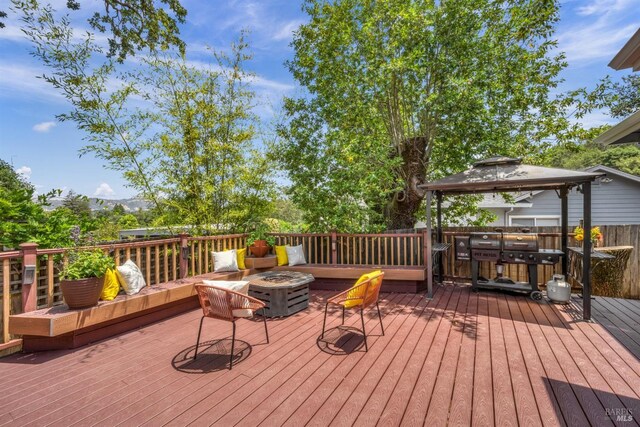deck with a gazebo and a fire pit