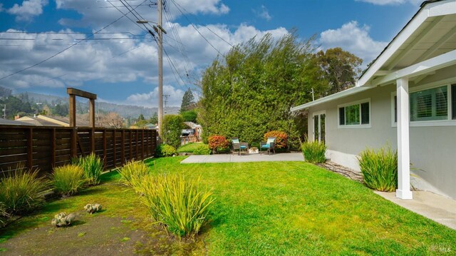 view of yard featuring a patio area and fence