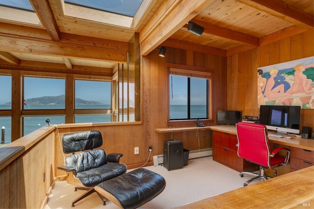 office space with beamed ceiling, a healthy amount of sunlight, a baseboard heating unit, and wooden walls