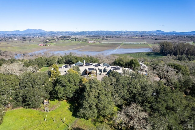 drone / aerial view with a water and mountain view