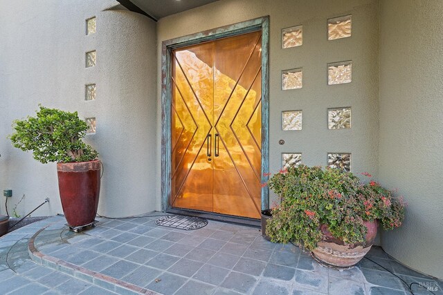 doorway to property with stucco siding