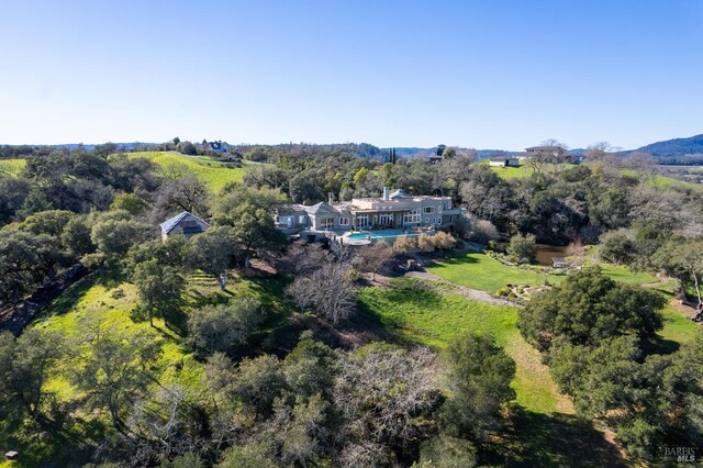 birds eye view of property with a view of trees