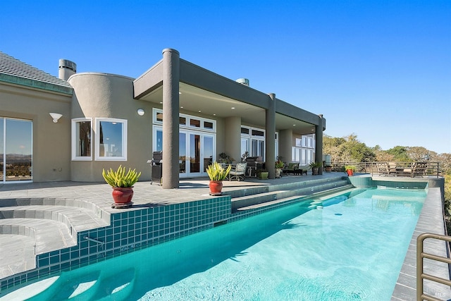 pool featuring a patio, french doors, and fence