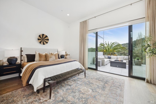 bedroom featuring recessed lighting, wood finished floors, and access to exterior