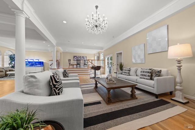living room with recessed lighting, wood finished floors, crown molding, and decorative columns