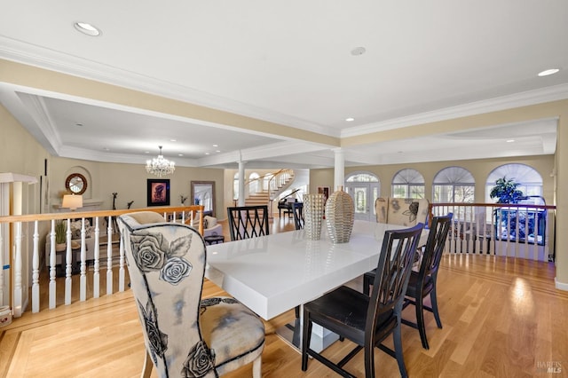 dining space featuring recessed lighting, ornate columns, light wood-style floors, crown molding, and a chandelier