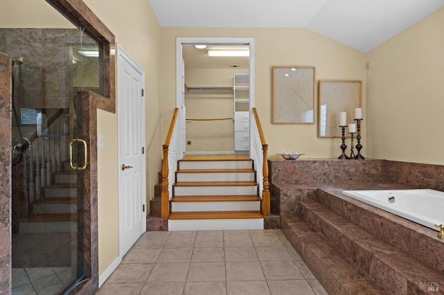staircase featuring lofted ceiling and tile patterned flooring