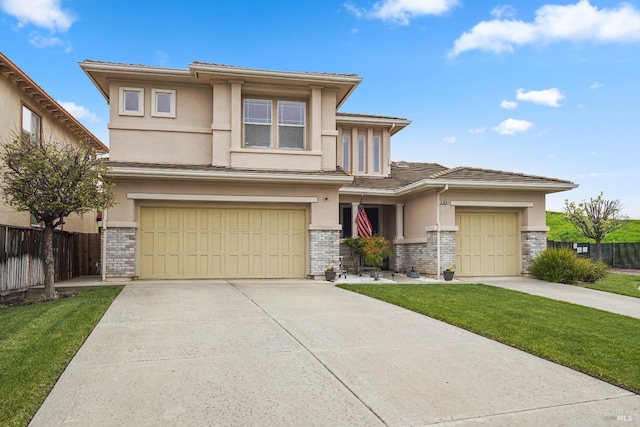 prairie-style house featuring fence, driveway, and stucco siding