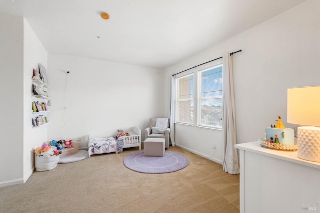 living area with baseboards and light carpet