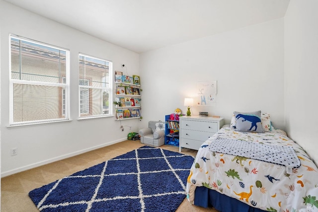 bedroom featuring carpet and baseboards