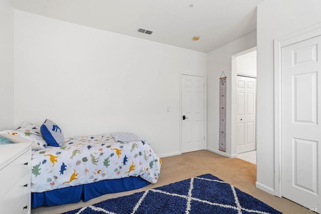 bedroom with visible vents, baseboards, and carpet