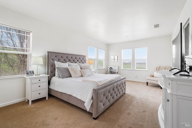 bedroom with visible vents, light colored carpet, and baseboards