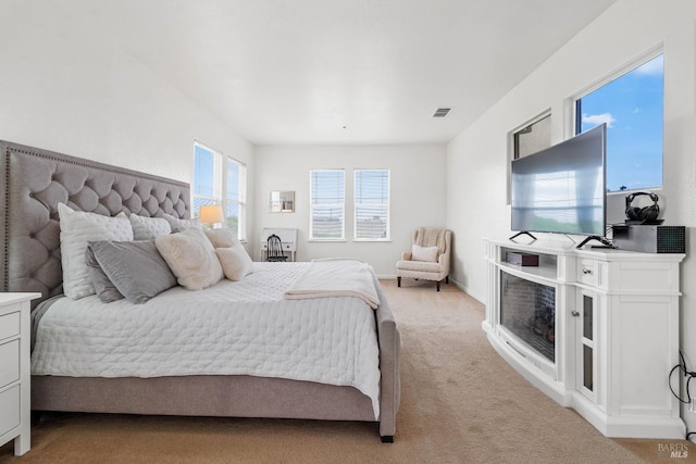bedroom featuring visible vents, baseboards, and light colored carpet