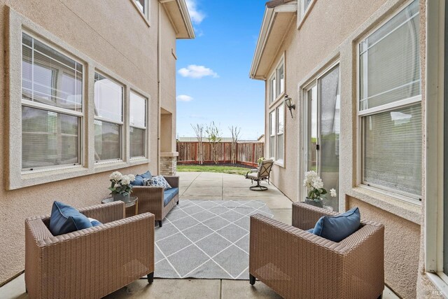 view of patio / terrace featuring an outdoor hangout area and fence