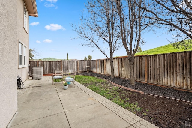 view of patio / terrace with central AC unit and a fenced backyard