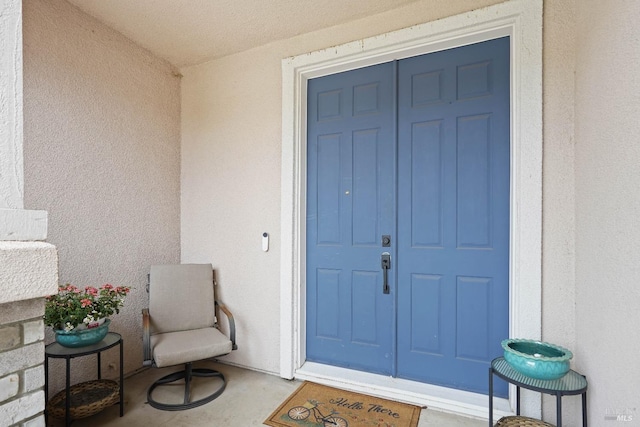 doorway to property with stucco siding