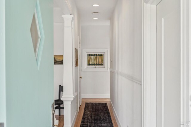 hallway featuring recessed lighting, baseboards, and wood finished floors