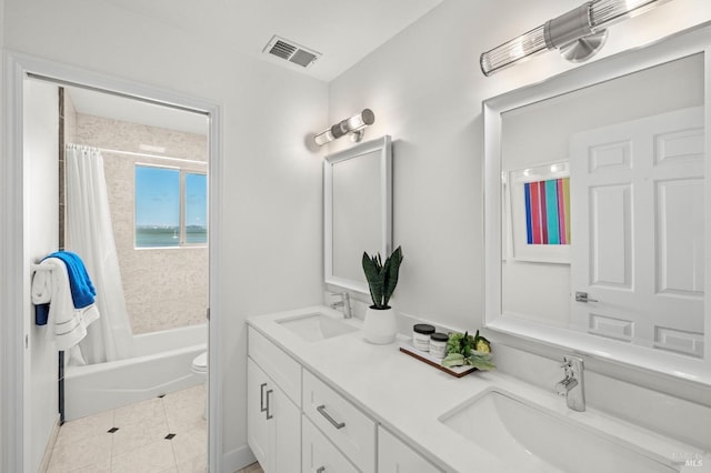 full bathroom featuring a sink, visible vents, double vanity, and tile patterned flooring