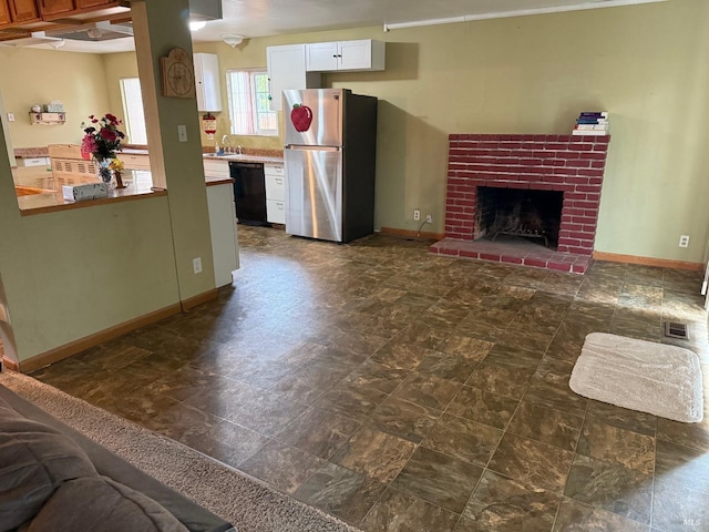 2024 San Luis St, Fairfield, CA 94533 - unfurnished living room featuring a brick fireplace, baseboards, and a sink