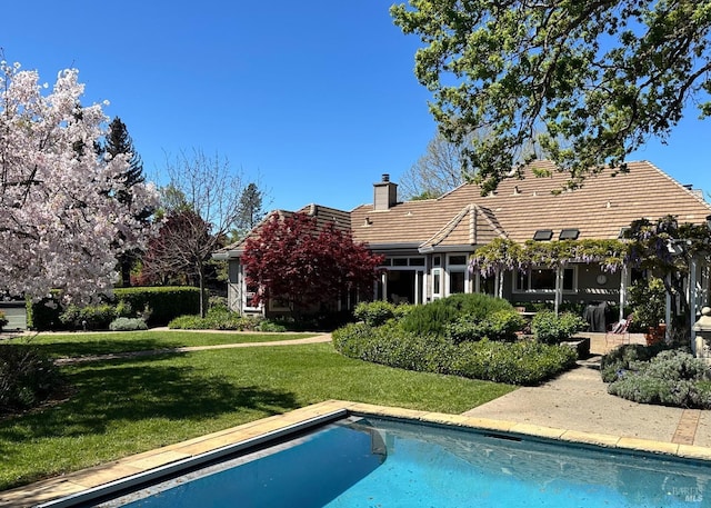 1706 Garnett Creek Ct, Calistoga, CA 94515 - back of house featuring a tile roof, a lawn, an outdoor pool, and a chimney