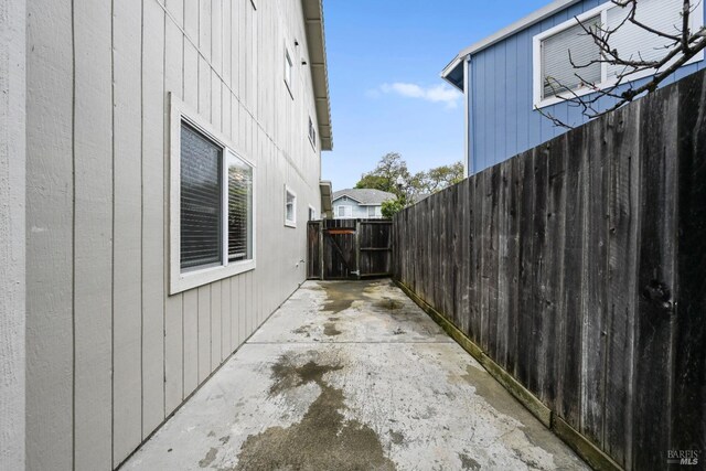 view of property exterior featuring a patio and fence