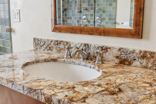 interior details with tiled shower and vanity