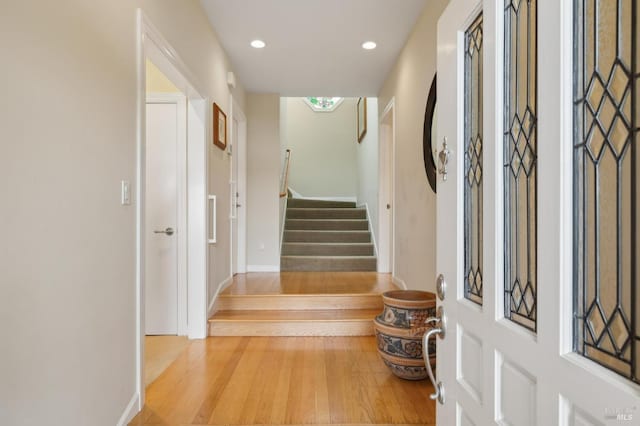 interior space with recessed lighting, stairs, and wood finished floors