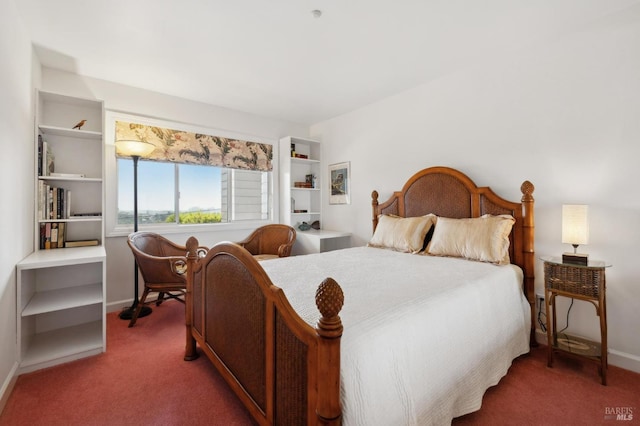 carpeted bedroom featuring baseboards