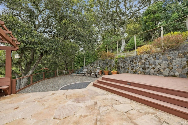 view of patio with a pergola and fence